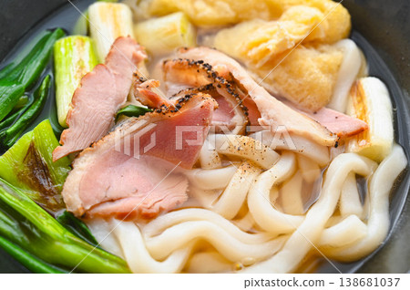Udon noodles with duck, grilled green onions, and fried tofu Udon noodles with duck, grilled green onions, and fried tofu 138681037
