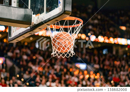 Basketball going through the hoop Basketball going through the hoop 138682008