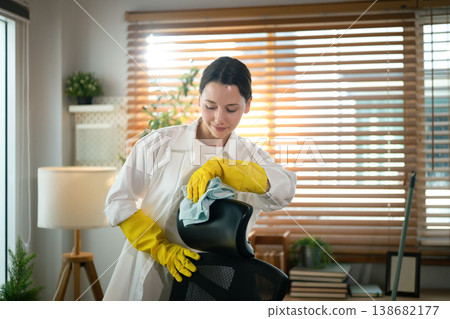 Caucasian Woman Cleaning Office Chair at Home Workspace Caucasian Woman Cleaning Office Chair at Home Workspace 138682177