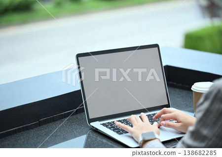 Close image of businesswoman using laptop at on office terrace Close image of businesswoman using laptop at on office terrace 138682285