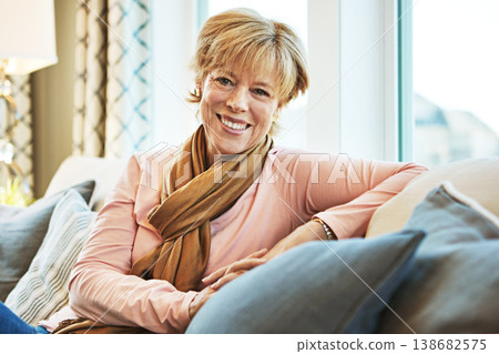 Portrait, smile or mature woman on sofa to relax with freedom on living room couch at home. Apartment, calm or happy senior person with peace or wellness in retirement, lounge or house for resting 138682575