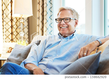 Thinking, happy or mature man on sofa to relax with calm on living room couch at home for resting. Ideas, glasses or senior male person with smile, peace or wellness in retirement, lounge or house Thinking, happy or mature man on sofa to relax with calm on living room couch at home for resting. Ideas, glasses or senior male person with smile, peace or wellness in retirement, lounge or house 138682920