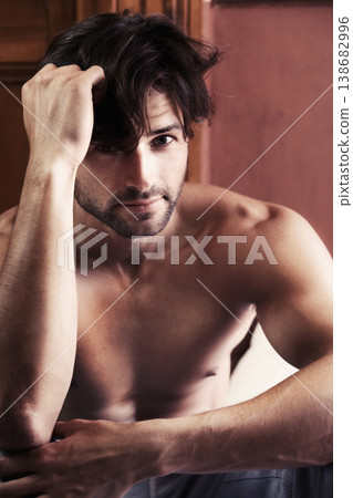 Portrait, man and serious shirtless in bedroom with look on face while thinking. Young, male person and alone in home with stare after wake up on vacation, holiday or break in morning for relaxation Portrait, man and serious shirtless in bedroom with look on face while thinking. Young, male person and alone in home with stare after wake up on vacation, holiday or break in morning for relaxation 138682996