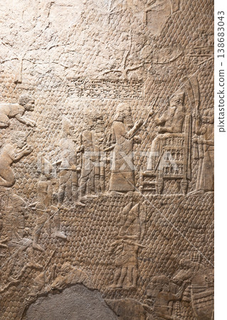 Ancient Assyrian stone relief carving of figures 138683043