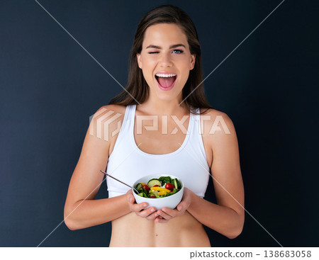 Happy woman, portrait and wink with salad for diet, lose weight or natural nutrition against a studio background. Female person or model with bowl of vegetables for food or healthy meal on mockup Happy woman, portrait and wink with salad for diet, lose weight or natural nutrition against a studio background. Female person or model with bowl of vegetables for food or healthy meal on mockup 138683058