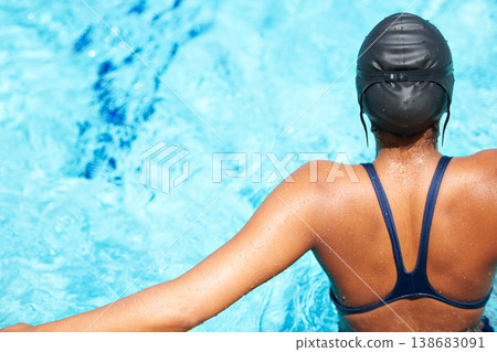 Back, swimming and pool with a sports woman for training, cardio workout or exercise for fitness. Female athlete person or professional swimmer in clear blue water for competition in swimsuit Back, swimming and pool with a sports woman for training, cardio workout or exercise for fitness. Female athlete person or professional swimmer in clear blue water for competition in swimsuit 138683091