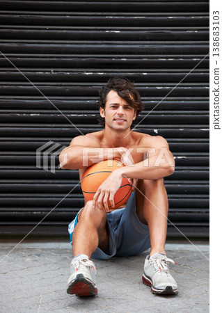 Basketball player, portrait or sports man relax, break and wellness after workout performance, exercise or practice. Active, athlete or urban person rest after fitness, shirtless and sitting on floor 138683103