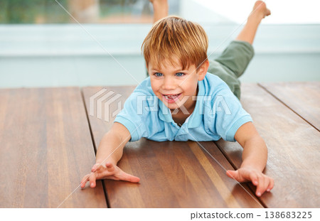 Child, excited and fantasy game on floor in family home, security and looking at object, energy and action with smile. Boy, happiness and fun in living room for love, care and play in kindergarten Child, excited and fantasy game on floor in family home, security and looking at object, energy and action with smile. Boy, happiness and fun in living room for love, care and play in kindergarten 138683225