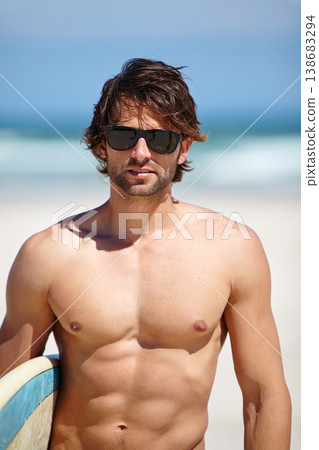 Beach, glasses and sports man on surfing holiday, vacation or relax adventure for freedom, summer or sea travel. Athlete abs, strong abdomen muscle and cool surfer with sunglasses on tropical island Beach, glasses and sports man on surfing holiday, vacation or relax adventure for freedom, summer or sea travel. Athlete abs, strong abdomen muscle and cool surfer with sunglasses on tropical island 138683294