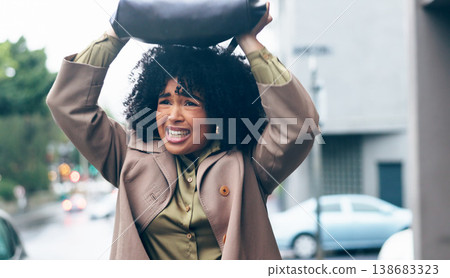 Rain, woman and bag in city for safety. security and shield with frustrated, sad or mad expression. Winter, african person and handbag on head for cover, water drops or protection in Cape Town road 138683323