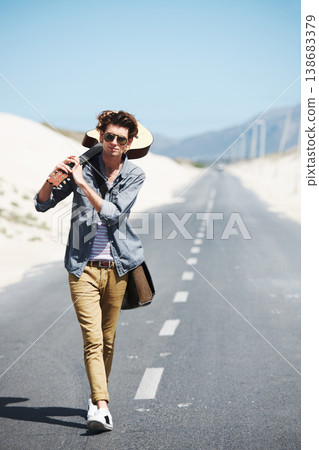 Walking, musician and man with a guitar on a road trip, highway or journey in countryside. Guitarist, trekking or lost on adventure and explore path in landscape with freedom on holiday or vacation Walking, musician and man with a guitar on a road trip, highway or journey in countryside. Guitarist, trekking or lost on adventure and explore path in landscape with freedom on holiday or vacation 138683379