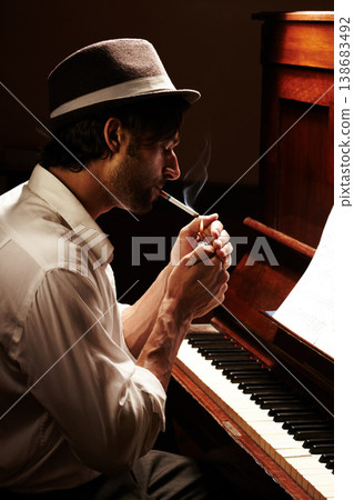 Creative, smoking and man with a piano, musician and practice with entertainment, performance and profile. Artistic, smoker and sound with instrument, tobacco and cigarette with music and jazz Creative, smoking and man with a piano, musician and practice with entertainment, performance and profile. Artistic, smoker and sound with instrument, tobacco and cigarette with music and jazz 138683492