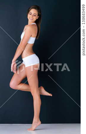 Attractive woman, body and relax in underwear for diet, fitness or weight loss against a studio background. Happy or gorgeous female person or model smile in slim, lean figure or health and wellness Attractive woman, body and relax in underwear for diet, fitness or weight loss against a studio background. Happy or gorgeous female person or model smile in slim, lean figure or health and wellness 138683499