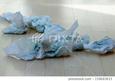 Dirty diapers scattered on wooden floor showing hygiene problem child care and cleaning Dirty diapers scattered on wooden floor showing hygiene problem child care and cleaning 138683615