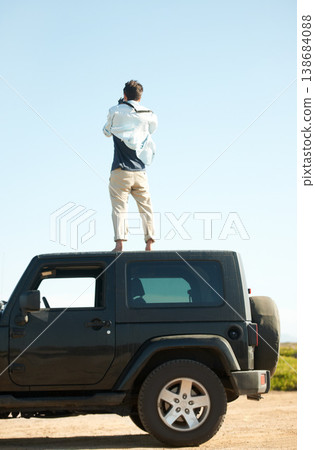 Man, photographer and camera on roof of car, summer road trip or vacation outdoor on mockup space. Back view, person on suv rooftop and photography of driver on transport, nature adventure or travel 138684088