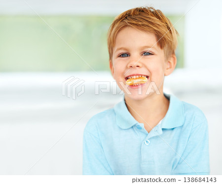 Child, portrait or orange fruit smile or health wellness snack, vitamin c or raw food youth development. Boy, face or mouth fresh diet or organic citrus nutrition, fibre breakfast or morning minerals Child, portrait or orange fruit smile or health wellness snack, vitamin c or raw food youth development. Boy, face or mouth fresh diet or organic citrus nutrition, fibre breakfast or morning minerals 138684143