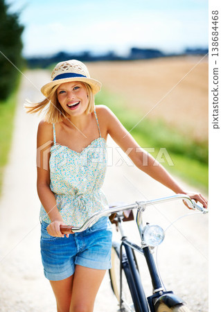 Travel, portrait and happy woman with a bicycle in the countryside for fitness while on vacation. Freedom, face and female person cycling in nature for holiday, trip or peaceful bike ride in France Travel, portrait and happy woman with a bicycle in the countryside for fitness while on vacation. Freedom, face and female person cycling in nature for holiday, trip or peaceful bike ride in France 138684468