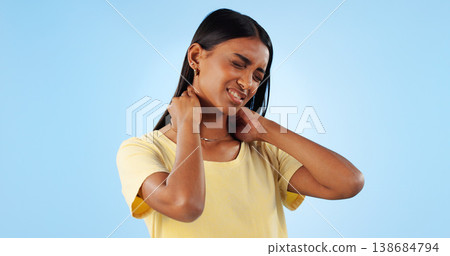 Neck pain, health and woman in studio with spine issue, emergency and bad posture on blue background. Muscle, pressure and fibromyalgia, sick with burnout and injury, mockup space and inflammation Neck pain, health and woman in studio with spine issue, emergency and bad posture on blue background. Muscle, pressure and fibromyalgia, sick with burnout and injury, mockup space and inflammation 138684794