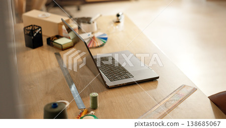 Laptop, ruler and design with color palette on desk for project, fashion or sample test in workshop. Computer, tools and thread for fabric, material or textile for art, clothes or production on table Laptop, ruler and design with color palette on desk for project, fashion or sample test in workshop. Computer, tools and thread for fabric, material or textile for art, clothes or production on table 138685067
