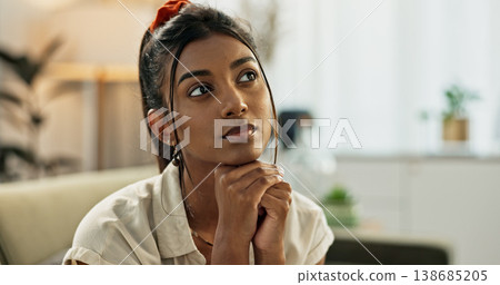Thinking, reflection and young woman on a sofa relaxing with an idea or memory in living room. Anxious, mental health and nervous Indian female person with decision in the lounge of modern apartment. Thinking, reflection and young woman on a sofa relaxing with an idea or memory in living room. Anxious, mental health and nervous Indian female person with decision in the lounge of modern apartment. 138685205