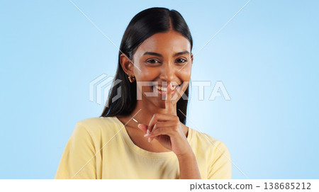 Secret, portrait and woman with finger on lips, gossip and announcement with emoji on a blue background. Person, face or model with privacy, mockup space or drama news with surprise, whisper or shush 138685212