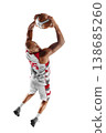 Basketball. Dynamic action shot of a basketball player performing an overhead throw from behind his head. Isolated 138685260