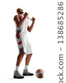 Basketball player. Emotional moment of a basketball player celebrating victory, pulling off his jersey in excitement 138685286