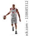 Basketball player in action. Basketball player in motion, running with the ball. Dynamic of a basketball player dribbling the ball. Isolated 138685312
