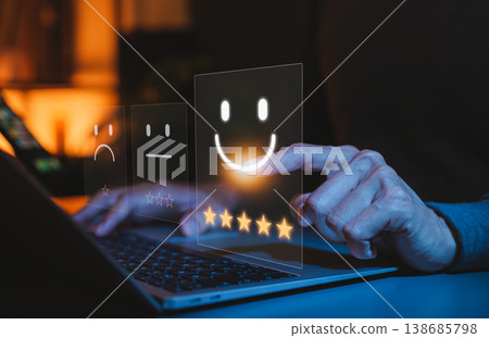 Customer satisfaction survey concept. User selecting a five star rating and happy emoji on laptop, representing positive online review, feedback, service quality evaluation, digital experience rating 138685798