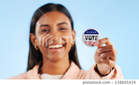 Woman, hand and pin for vote by showing in studio for mock up in politics on blue background. Indian person, smile and excited for government election or campaign with support in community engagement Woman, hand and pin for vote by showing in studio for mock up in politics on blue background. Indian person, smile and excited for government election or campaign with support in community engagement 138685814