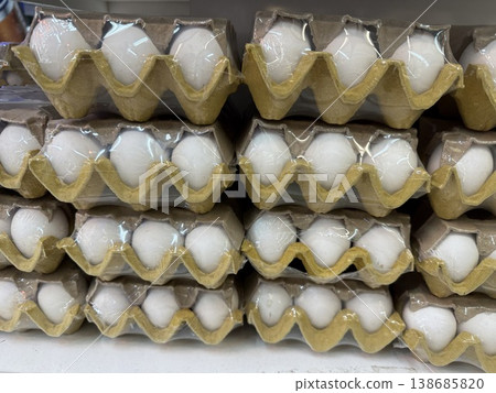 Egg cartons stacked in a neat arrangement, suitable for market theme or background 138685820