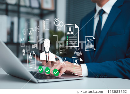 AI Recruitment and Resume Screening for Smart Hiring Process. HR professional using laptop with virtual resume, CV screening, candidate selection, interview, verification and talent acquisition. AI Recruitment and Resume Screening for Smart Hiring Process. HR professional using laptop with virtual resume, CV screening, candidate selection, interview, verification and talent acquisition. 138685862