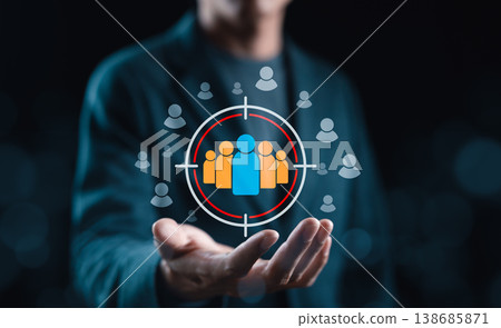 Audience Targeting and Customer Reach Concept. Person presenting a target audience icon with user symbols, representing customer segmentation, audience selection, market targeting and focused outreach Audience Targeting and Customer Reach Concept. Person presenting a target audience icon with user symbols, representing customer segmentation, audience selection, market targeting and focused outreach 138685871
