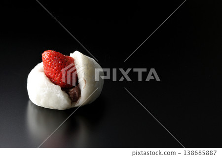Strawberry daifuku photographed alone against a black background. 138685887