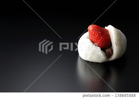 Strawberry daifuku photographed alone against a black background. 138685888