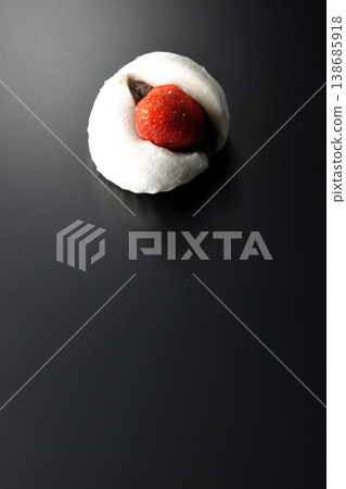 Strawberry daifuku photographed alone against a black background. Strawberry daifuku photographed alone against a black background. 138685918