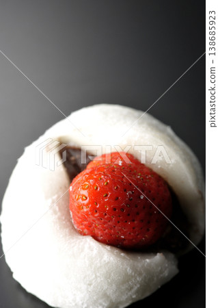 Strawberry daifuku photographed alone against a black background. Strawberry daifuku photographed alone against a black background. 138685923