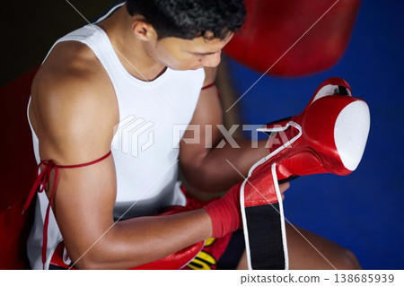 Strong, getting ready and a man with gloves for boxing, a fight competition or gym training. Fitness, club and a boxer or fighter with equipment to start sports, exercise or martial arts match Strong, getting ready and a man with gloves for boxing, a fight competition or gym training. Fitness, club and a boxer or fighter with equipment to start sports, exercise or martial arts match 138685939