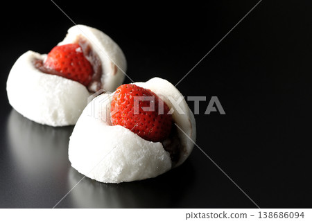 Strawberry daifuku photographed against a black background Strawberry daifuku photographed against a black background 138686094