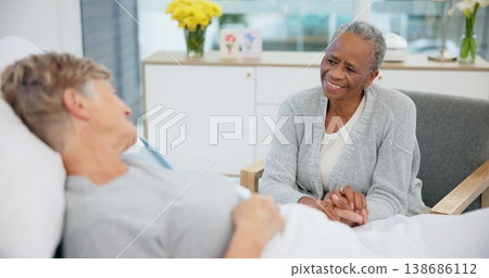 Senior woman, friend and holding hands in hospital bed with conversation, care and support for recovery from surgery. Clinic visit, empathy or elderly lady with smile, chat and listen with solidarity Senior woman, friend and holding hands in hospital bed with conversation, care and support for recovery from surgery. Clinic visit, empathy or elderly lady with smile, chat and listen with solidarity 138686112