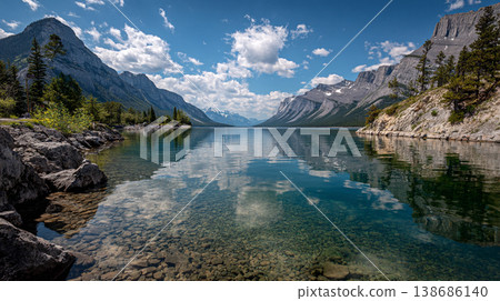 A breathtaking view turquoise lake waters reflecting snow-capped peaks. The scene features dense pine forests and soft morning mist drifting across the rugged Canadian Rockies. 138686140