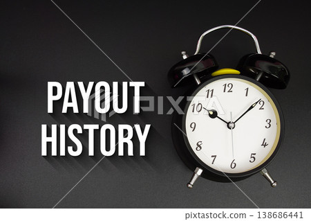 Payout History text with alarm clock on black background Payout History text with alarm clock on black background 138686441