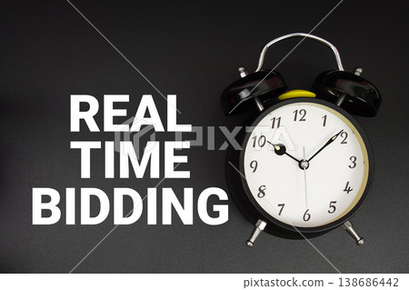 Real Time Bidding text with alarm clock on black background Real Time Bidding text with alarm clock on black background 138686442