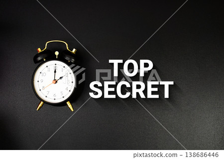 Top Secret text with alarm clock on black background Top Secret text with alarm clock on black background 138686446