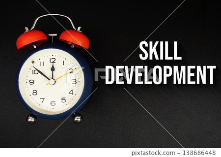 Skill Development text with alarm clock on black background 138686448
