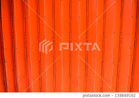 Close-up of old shutter door. Metallic rusty texture stripe pattern on door. For background. Close-up of old shutter door. Metallic rusty texture stripe pattern on door. For background. 138689102