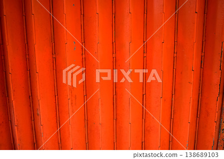 Close-up of old shutter door. Metallic rusty texture stripe pattern on door. For background. Close-up of old shutter door. Metallic rusty texture stripe pattern on door. For background. 138689103