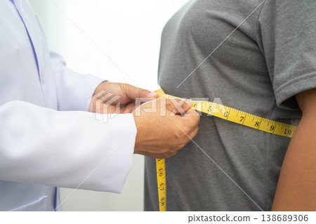 Asian woman with fat belly big size overweight and obesity with measure tape. Asian woman with fat belly big size overweight and obesity with measure tape. 138689306