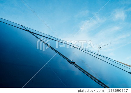 Close up solar power roof panel on Modern, energy-efficient house with blue sky background. Renewable eco Energy. Concept of economy and profit from selling excess electricity. Smart energy management 138690527