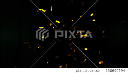 Flying golden confetti on black background. Shiny particles suspended in the air with dramatic lighting, creating a festive, luxury and celebratory atmosphere. Flying golden confetti on black background. Shiny particles suspended in the air with dramatic lighting, creating a festive, luxury and celebratory atmosphere. 138690594